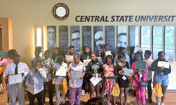 Students holding their certificates at the closing ceremony.
