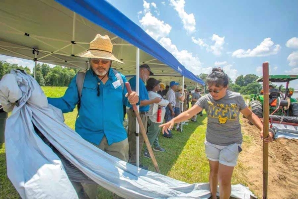 Kathleen Liang works with plasticulture during a field day.