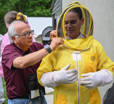Person in a beekeeper suit.