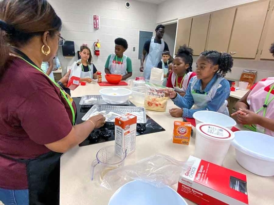 Discovery Day Camp students practice measuring skills.