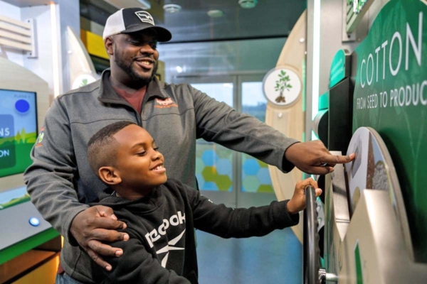 Man and boy inside Mobile Education Unit.