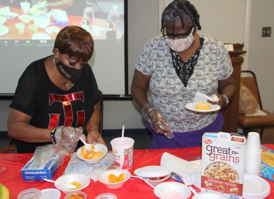 Two family and consumer sciences agents make healthy snacks.
