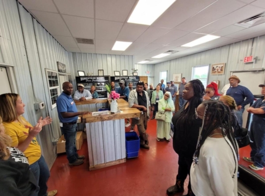 Conference participants listening to a speaker at the Homestead Meats Processing Plant.