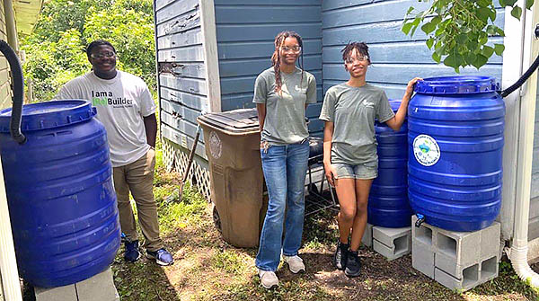 Students install rain barrels.
