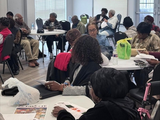 People gathered at tables for a workshop.