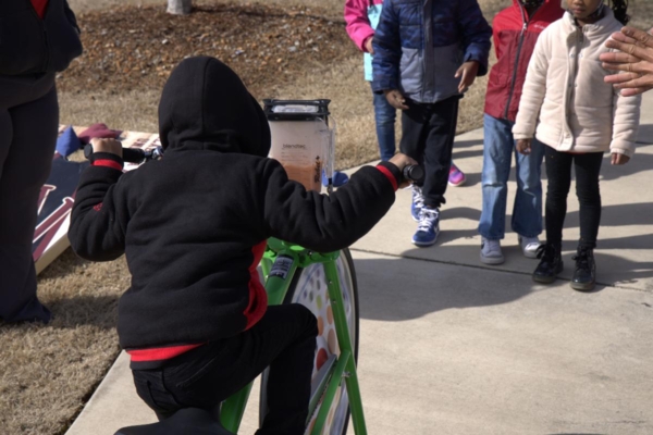 Child on smoothie bike.