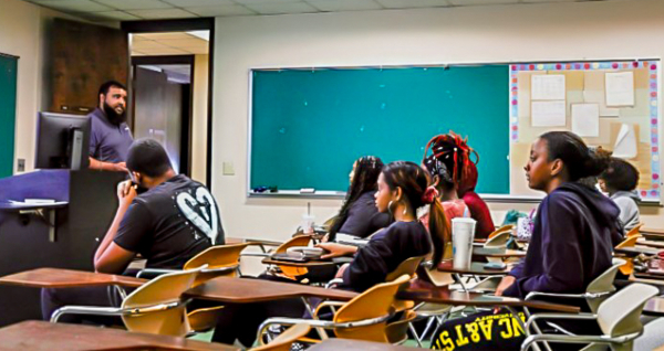 Educator discusses the pros and cons of lab-grown meat with students.