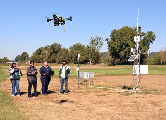 Students operate a drone.