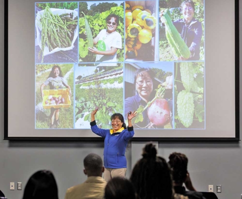 Dr. Kathleen Liang presents to a crowd of farmers.